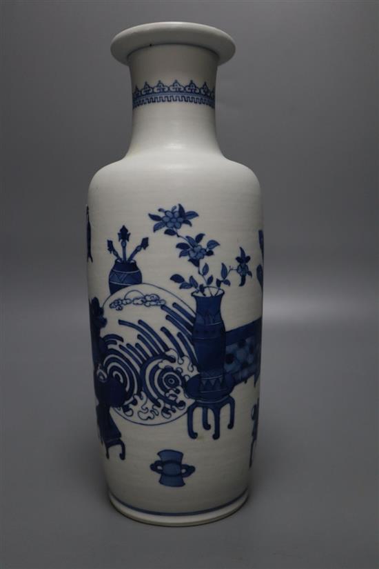 A Chinese blue and white rouleau vase, painted with domestic objects in underglaze blue, height 24cm